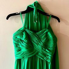 a green dress hanging on a hanger