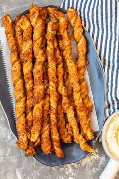 fried chicken sticks on a plate with dipping sauce