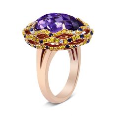 There are no words to truly describe this vividly colorful ring set in 18K Yellow and Rose Gold. The ring starts with a masterfully cut, checkboard purple amethyst set with 4 claw prongs. This magnificent purple stone measures 12mm x 11mm and gives off flashes of deep purple. The centerpiece is then finished with a yellow gold halo complete with a dazzling array of blue and yellow sapphires and white diamond accents. The entire piece sits on a rose gold band. YouÃ¢â‚¬â„¢ll never see another ring Colorful Ring, Amethyst Set, Color Violeta, Claw Prong, Gold Halo, Rose Gold Band, Purple Stones, Emerald Jewelry, Color Ring