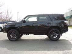 a black suv parked in a parking lot