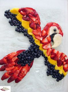 a cake made to look like a parrot with fruit on it