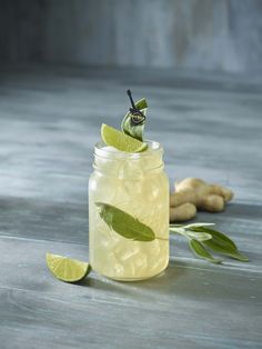 a glass jar filled with lemonade and lime