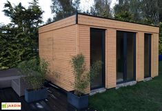 a small wooden building sitting on top of a lush green field