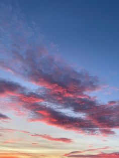 the sky is pink and blue at sunset