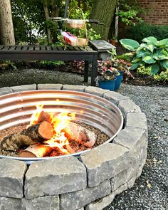 an outdoor fire pit with logs in it