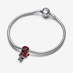 Pay tribute to a brave and goofy character with the Marvel Deadpool Charm. Marvel's Deadpool is depicted in sterling silver with metallic-effect enamel in basse-taille technique revealing a woven pattern beneath Deadpool's fully-equipped body suit. Intricate detailing brings this charm to life, showing Deadpool mid-action with one hand forming a peace sign. No Marvel fan's collection is complete without this charm that celebrates the goofy and brave-hearted Deadpool character. - Pandora Marvel Deadpool Charm - Enamel / Sterling silver / Red Pandora Marvel, Goofy Character, Deadpool Character, Pearl Diamond Jewelry, Pandora Essence, Custom Charm Bracelet, Gold Armband, Solid Gold Necklace, Marvel Deadpool