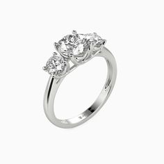 For the soon to be bride searching for effortless radiance, look no further than this engagement ring from SHE·SAID·YES. A brilliant center stone is nestled within four-prong claws, accented with two sparkling round stones on each side;  Wearing this ring will make you feel like a princess. Carat Weight: 1 ctStone Size: 6.5 mmStone Type: Moissanite/GemstoneNumber of Stones: 1 Stone Color: OptionalStone Shape: RoundCarat Weight: 0.8 ctStone Size: 4.5 mmStone Type: Moissanite/GemstoneNumber of Sto Wedding Three Stone Lab Grown Diamond Ring, Cushion Cut Three Stone Wedding Ring, Lab Grown Diamond Three Stone Wedding Ring, Classic Three Stone Lab Grown Diamond Wedding Ring, Three Stone Lab Grown Diamond Rings For Wedding, Cushion Cut Three Stone White Gold Ring, Silver Three Stone Asscher Cut Jewelry, Elegant Three Stone Promise Diamond Ring, Elegant Three Stone Round Band Wedding Ring