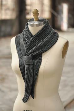 a white mannequin with a black scarf on it