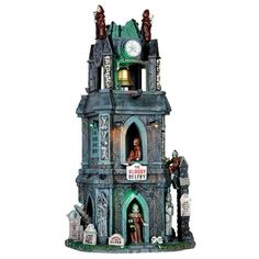 a tall clock tower with statues on it