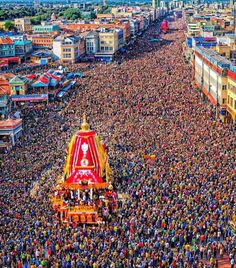 an aerial view of a large crowd in the middle of a city with a float on it's side