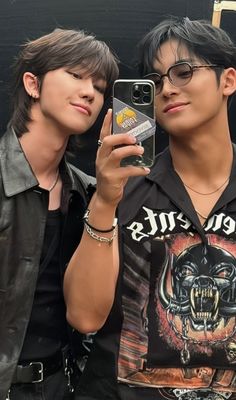 two young men taking a selfie with their cell phones