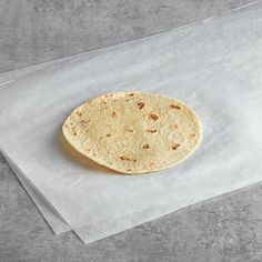 a tortilla sitting on top of a piece of white paper