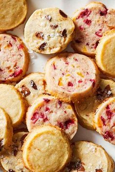 a white plate topped with cookies covered in cranberry filling