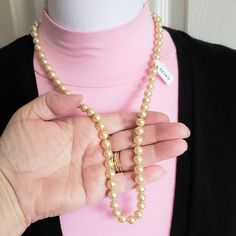 ♥Vintage 8mm beige or off white glass faux pearl necklace 24 inches long with a sterling fish hook style clasp. This necklace is in very good condition. Enjoy! To see more vintage necklaces, pendants, and dress clips in my shop, please click here: https://www.etsy.com/shop/JulesBaublesandMore?ref=seller-platform-mcnav&section_id=19097834 The mannequin is not an accurate representation of where the center of this necklace will fall when being worn as it really depends on the measurements of the person wearing it. Fancy it for yourself or as a gift for the special someone whom you know will adore and treasure this piece from the past. Enjoy! Stand out from the crowd just a little bit more by purchasing and wearing accessories that are uncommon, unique, and perhaps one of a kind when it comes Vintage Adjustable Single Strand Pearl Necklace, Formal Pearl Necklace With Lobster Clasp, Classic Cream Round Beads Jewelry, Classic Cream Round Bead Jewelry, Classic Beige Jewelry For Formal Occasions, Formal Cream Single Strand Necklace, Vintage Pearl Necklace With Lobster Clasp, Vintage Pearl Jewelry With Lobster Clasp, Formal Cream Necklace With Pearl Charm