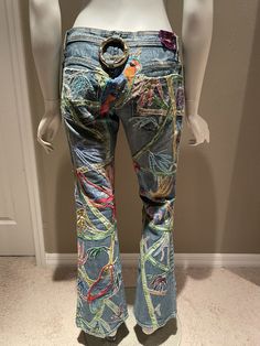 a mannequin wearing jeans with colorful designs on them