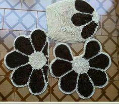 three black and white rugs sitting on top of a tile floor next to a basket