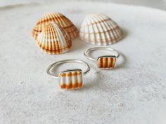 * Unique Sea Shell Fragments  have been collected, up-cycled and  set into these unique OOAK rings !  *Collected from my travels around the Greek Islands . *The sea shells are natural - Please allow for differences in color and size. *The ring's band measures 1.5cm *This ring is made to order.It will come beautifully gift wrapped for you or your beloved ! You can find more rings here : https://www.etsy.com/shop/CorneliousWhite?ref=l2-shopheader-name§ion_id=19408283 Thank you so much for stopping Silversmith Rings, Summer Rings, Silver Sea, Jewelry Tattoo, Shell Ring, Jewelry Companies, Greek Islands, Sea Shell, Cute Jewelry