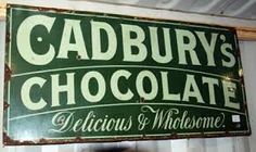 a sign for cadbury's chocolate hangs on the wall