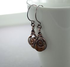 "These statement artisan copper earrings are made with 16 gauge solid copper wire in drop shape, accented with swirls and honey brown color Picasso finish Czech glass briolette hanging from handmade with 18 gauge solid copper wire earwires and were tumbled, oxidized and hand polished for more strength and character. The earrings are approximately 2 1/4\"(5.5cm) in length in total and 5/8\"(1.5cm) across at the widest part. ATTENTION - ORDERS TO US AND INTERNATIONAL: All orders ship from Toronto, Brown Copper Wire Drop Earrings, Copper Wire Wrapped Brown Earrings, Brown Copper Wire Wrapped Earrings, Wire Wrapped Brown Copper Earrings, Honey Brown Color, Aztec Earrings, Homemade Earrings, Earring Ideas, Honey Brown