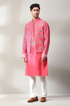 Dark pink bundi with mirror, thread embroidery in floral pattern. Paired with placket embroidered kurta and off-white pant. - Aza Fashions Pink Chanderi Sherwani With Resham Embroidery, Pink Chanderi Sherwani With Zari Work, Pink Nehru Jacket With Resham Embroidery For Reception, Festive Pink Chanderi Sherwani, Unstitched Pink Nehru Jacket With Zari Work, Pink Unstitched Nehru Jacket With Zari Work, Pink Bandhgala With Chikankari Embroidery, Pink Sherwani With Mirror Work For Designer Wear, Pink Fitted Nehru Jacket