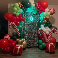 the balloon arch is decorated with candy canes and lollipops for christmas