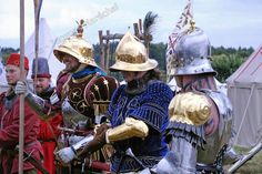 men dressed in medieval armor standing next to each other