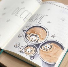 an open book with some drawings on the pages and coffee in it's middle