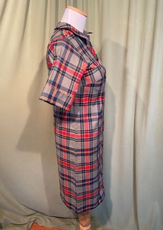 "This is a cute vintage dress from the 60's. No labels or tags. There isn't a size tag. The bust measures 30\", waist 30\", see measurements below. Made of gray, blue, red & yellow cotton blend, permanent press fabric. The dress is not lined. It has short sleeves, that can be worn cuffed or down. The collar is small. Buttons all the way down the front. The shape is very straight. A previous owner hand hemmed the hemline up 1.5\" & I left it up. Looks like it could be taken down without l Fitted Retro Button-up Vintage Dress, Retro Fitted Button-up Vintage Dress, Retro Button-up Dresses For Daywear, Vintage Plaid Dress With Button Closure, Plaid Short Sleeve Shirt Dress For Daywear, Retro Fitted Shirt Dress With Buttons, Retro Fitted Button-up Shirt Dress, Retro Collared Dress With Button Closure, Fitted Retro Shirt Dress For Daywear