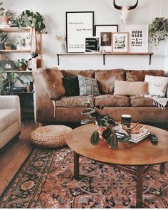 a living room filled with lots of furniture and plants on top of a coffee table