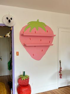 there is a strawberry shaped shelf on the wall