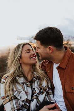 a man and woman smile at each other