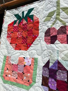 a close up of a quilt with fruit on it