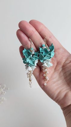 https://purplebeestudio.etsy.com Handmade unique polymer clay chandelier earrings. These very delicat earrings in trendy mint colour with imitation pearl beads beads will become your favorits for many occasions.  Perfect gift for a special woman in your life. Earrings made with brass ear wire.  SHIPPING: Your order will be dispatched in a securely packed cardboard box. Product care:  - To ensure the product quality and durablility, avoid contact with water, lotion, perfumes and household cleaners and chemicals. - You can clean the products with a slightly damp soft fabric.  - Sharp objects can damage the clay surface. - When not in use, store in a dry, seperate box. Thank you for visiting my shop! If you have any special requests, I'll be happy to do my best to accommodate. Please let me k Wedding Polymer Clay Flower Dangle Earrings, Clay Chandelier, Mint Flower, Mint Flowers, Clay Works, Long Flowers, Jewelry Bridesmaid, Sharp Objects, Earrings Wedding