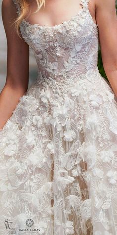 the back of a wedding dress with flowers on it