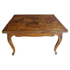 a wooden table with an intricate design on the top