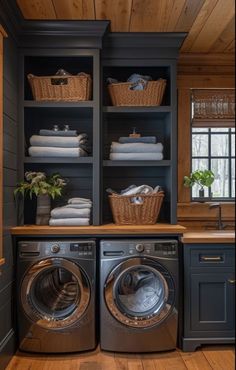 a washer and dryer in a room with wooden floors, built - in shelving