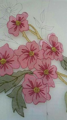 pink flowers on white fabric with green leaves and gold thread work in the middle,