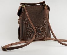 Introducing our Women's Leather Backpack: a stylish brown boho pack with a unique embossed design. Crafted with both fashion and functionality in mind, this backpack is perfect for the modern woman seeking a blend of style and practicality. Featuring one main section and a small pocket for your mobile phone, along with a button to securely fix your keys, this bag ensures easy organization and quick access to your essentials. The adjustable shoulder strap, with a length range of 47.2 to 31.5 inch Bar Accessories Decor, Classic Office, Women Leather Backpack, Unique Bags, Office Accessories, Bar Accessories, Handmade Accessories, Leather Backpack, Leather Women