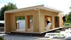 two men are working on a tiny house