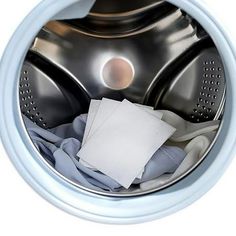 a close up of a washing machine filled with clothes