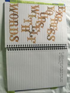 a spiral notebook with the words happy new year written on it and gold glitters