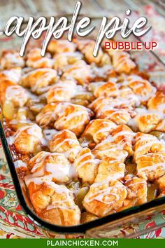 a casserole dish filled with cinnamon rolls covered in icing and drizzled