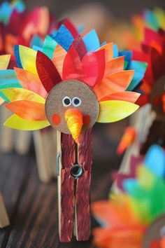 a paper turkey on a stick made out of wood sticks