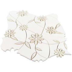 three white and gold flower coasters sitting on top of each other