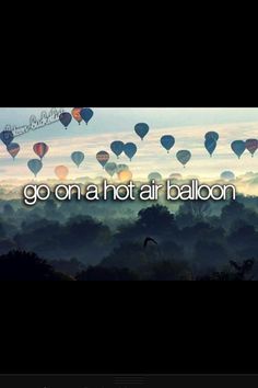 the words go on a hot air balloon are in front of many balloons flying through the sky