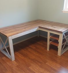 a corner desk made out of two different pieces of wood with one bench on the other side