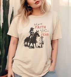 This unisex, relaxed-fit tee is more than just clothing; it's a statement of your beliefs, a conversation starter, and a source of inspiration. Crafted with love and devotion, this T-shirt is designed to reflect your faith and share a message of hope and love with the world. ✨Features✨ Material: High-quality, pre-shrunk, 100% cotton for softness and durability. Style: Relaxed fit with a classic crew neck and short sleeves. Sizes: A wide range of sizes for a perfect fit for everyone. Comfort Colors is known for its exceptional quality and comfortable feel. 🤍Care Instructions🤍 Machine wash cold, inside out; tumble dry low for best results. ✨Return Policy✨ All shop sales are final. We do not accept returns - only exchanges. Please double-check your order before you submit. Changes cannot be Horse Western, Cowgirl Shirts, Message Of Hope, Christian Shirt, Faith Over Fear, Western Shirt, Western Shirts, Christian Shirts, Conversation Starters