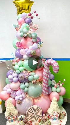 a very colorful christmas tree decorated with balloons