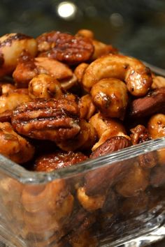 a glass bowl filled with nuts on top of a table