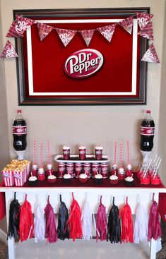 a table topped with cupcakes and cake next to a sign that says dr pepper